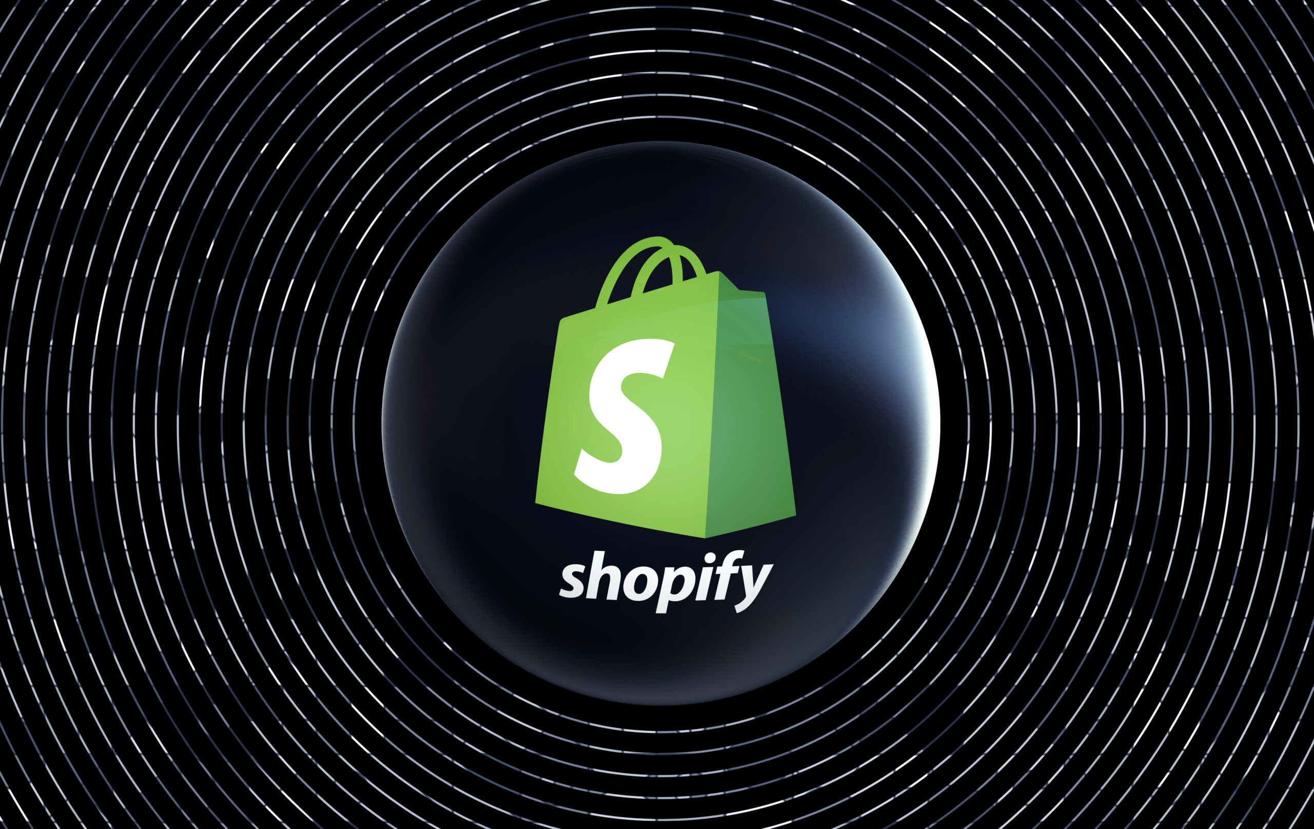 Shopify logo surrounded by white circle etching on a black background