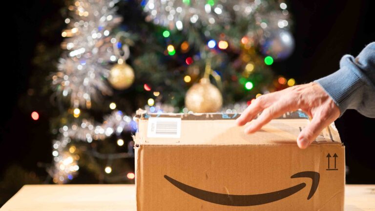 Amazon box in front of Christmas tree, indicating new Amazon inventory announcements