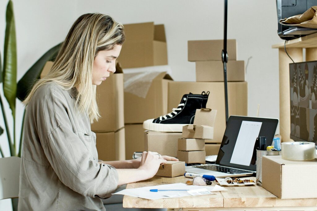 woman working on her laptop to learn how to run a sale on Shopify for her business